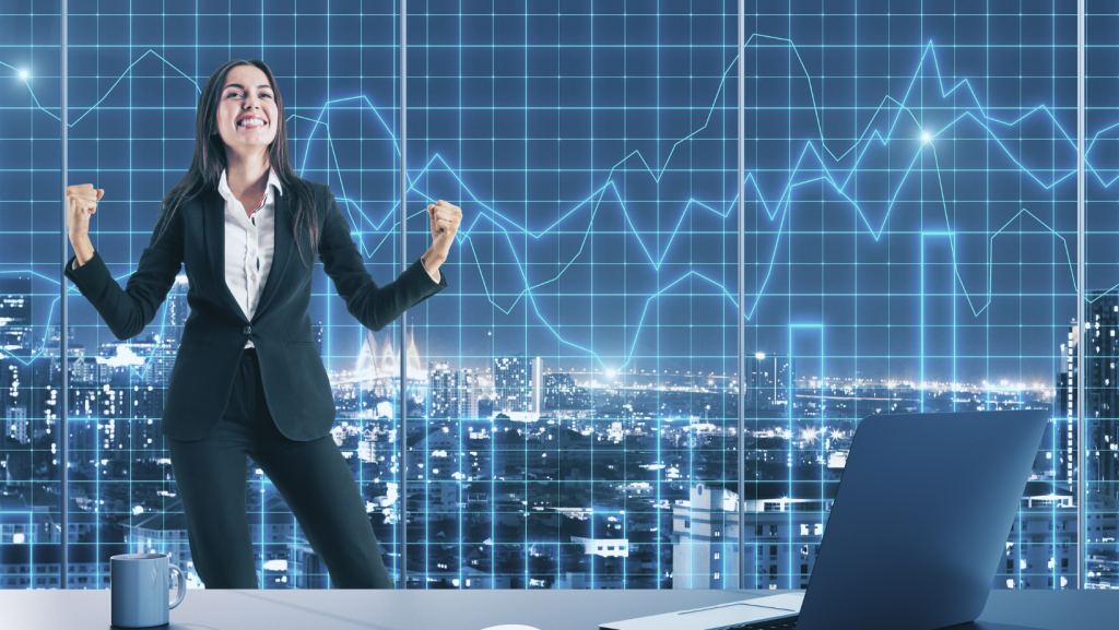 happy woman dancing in front of trading charts